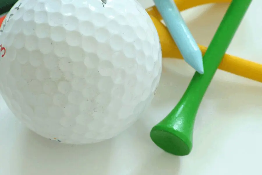 A close up of a golf ball and a tee