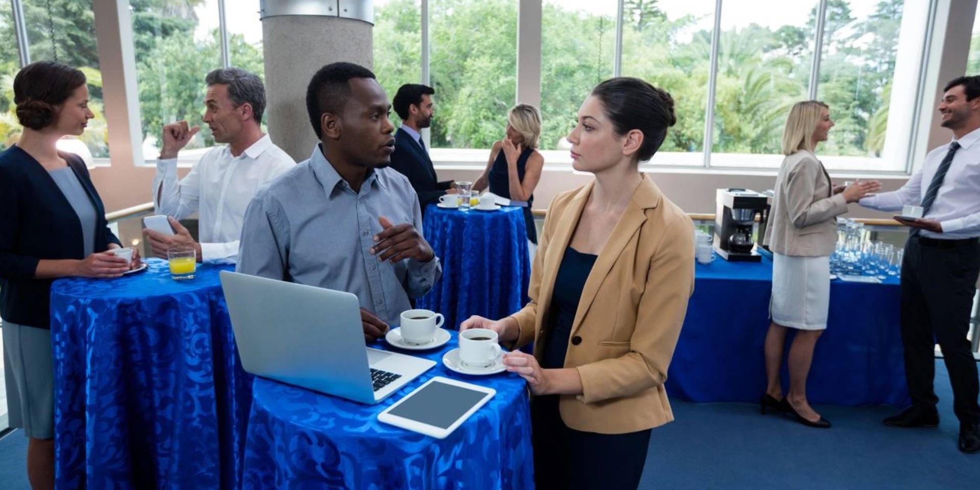 Two people are talking to each other at a table.