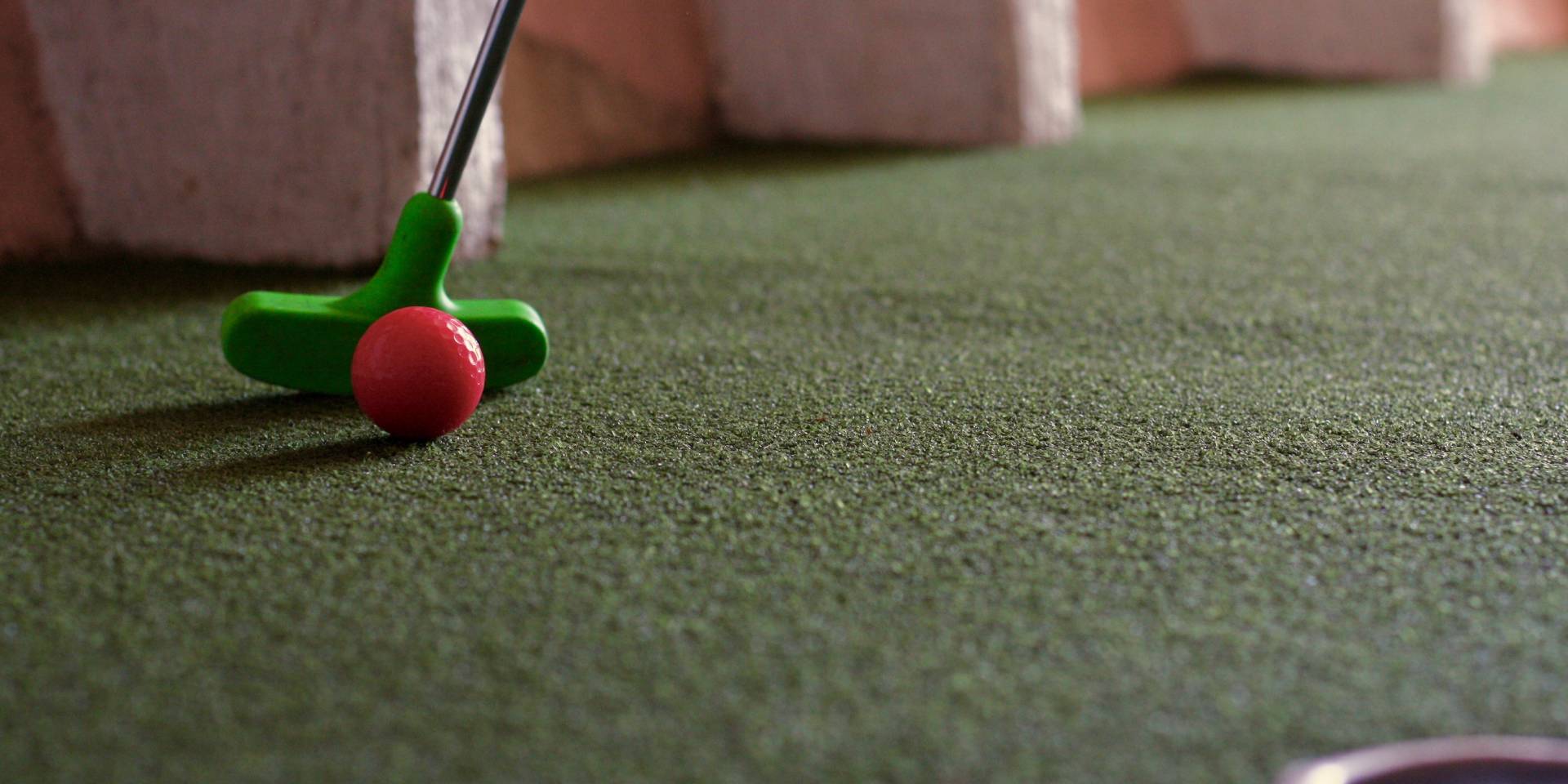 A close up of a toy golf club on the floor